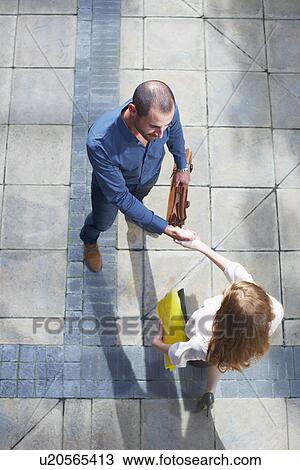Businessman and business woman shaking hands View Large Photo Image Stock Image - Businessman and business woman shaking hands. Fotosearch