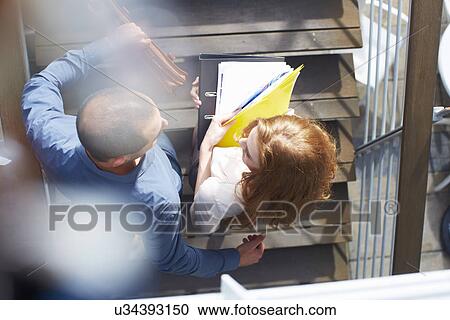 Businessman and business woman with paperwork View Large Photo Image Stock Image - Businessman and business woman with paperwork. Fotosearch