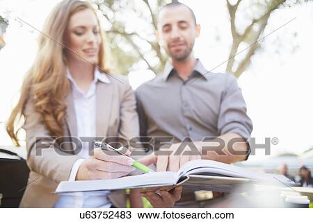 Businessman and business woman with paperwork View Large Photo Image Stock Image - Businessman and business woman with paperwork. Fotosearch