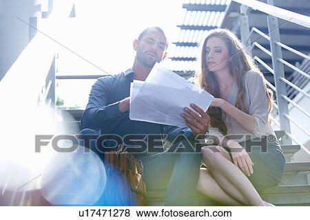 Businessman and business woman with paperwork View Large Photo Image Stock Photo - Businessman and business woman with paperwork. Fotosearch