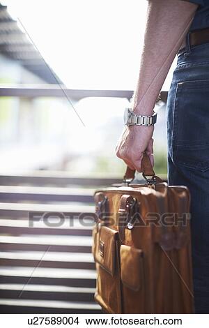 Businessman carrying briefcase View Large Photo Image Picture - Businessman carrying briefcase. Fotosearch