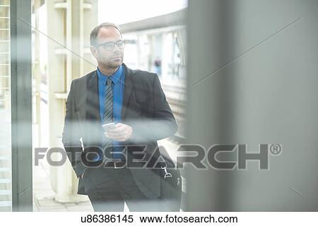 Businessman holding cell phone View Large Photo Image Stock Photography - Businessman holding cell phone. Fotosearch