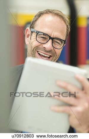 Stock Image - Businessman using digital tablet. Fotosearch