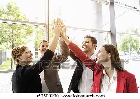 Stock Image - Businessmen and businesswomen cheering. Fotosearch
