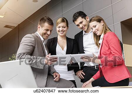 Businessmen and businesswomen sharing information on digital tablet View Large Photo Image Stock Photo - Businessmen and businesswomen sharing information on digital tablet. Fotosearch