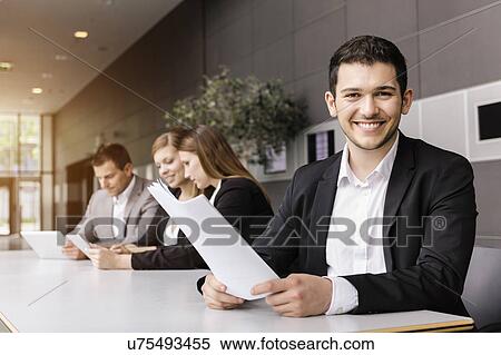 Businessmen and businesswomen with digital tablet at meeting table View Large Photo Image Stock Photography - Businessmen and businesswomen with digital tablet at meeting table. Fotosearch