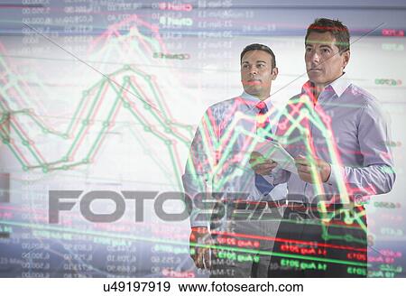Businessmen inspecting graph on interactive futuristic display View Large Photo Image Stock Photo - Businessmen inspecting graph on interactive futuristic display. Fotosearch