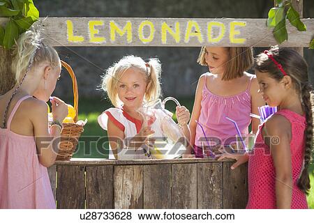 Candid portrait of four girls at lemonade stand in park View Large Photo Image Stock Photo - Candid portrait of four girls at lemonade stand in park. Fotosearch