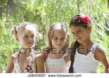 Candid portrait of three girls in garden View Large Photo Image Stock Photo - Candid portrait of three girls in garden. Fotosearch