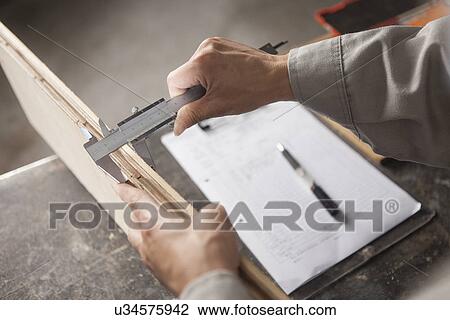 Carpenter measuring wood plank with vernier caliper in factory, Jiangsu, China View Large Photo Image Stock Image - Carpenter measuring wood plank with vernier caliper in factory, Jiangsu, China. Fotosearch