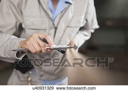 Carpenter measuring wood plank with vernier caliper in factory, Jiangsu, China View Large Photo Image Stock Photo - Carpenter measuring wood plank with vernier caliper in factory, Jiangsu, China. Fotosearch