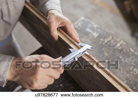 Carpenter measuring wood plank with vernier caliper in factory, Jiangsu, China View Large Photo Image Stock Photo - Carpenter measuring wood plank with vernier caliper in factory, Jiangsu, China. Fotosearch