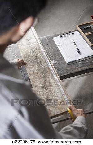 Carpenter measuring wood plank with tape measure in factory, Jiangsu, China View Large Photo Image Stock Photography - Carpenter measuring wood plank with tape measure in factory, Jiangsu, China. Fotosearch