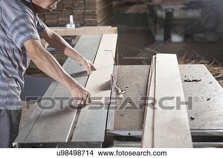 Carpenter working with wood plank in factory, Jiangsu, China View Large Photo Image Picture - Carpenter working with wood plank in factory, Jiangsu, China. Fotosearch