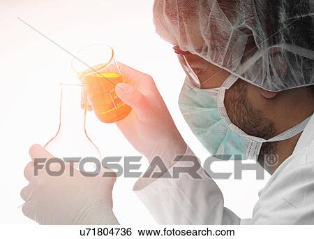 Chemist pouring liquid from beaker into flask View Large Photo Image Stock Photograph - Chemist pouring liquid from beaker into flask. Fotosearch