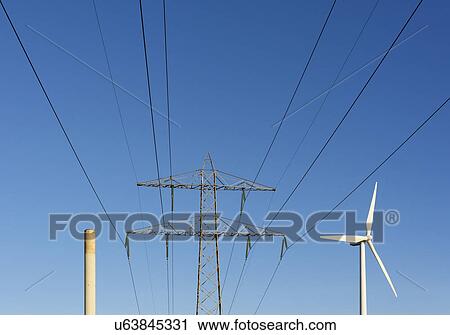 Stock Image - Chimney belonging to a coal-fired power station, and a modern wind turbine. Fotosearch