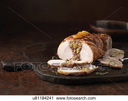 Stock Image - Christmas dinner. Boneless double stuffed turkey with sage, apricots and bacon. Fotosearch
