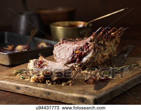 Christmas dinner. Lamb rack rare medium with cranberry and clementine stuffing and rosemary View Large Photo Image Stock Image - Christmas dinner. Lamb rack rare medium with cranberry and clementine stuffing and rosemary. Fotosearch