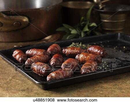 Christmas dinner snack. Festive spiced bacon and venison cocktail sausage rolls. Pigs in blankets with thyme bay leaves View Large Photo Image Stock Photo - Christmas dinner snack. Festive spiced bacon and venison cocktail sausage rolls. Pigs in blankets with thyme bay leaves. Fotosearch
