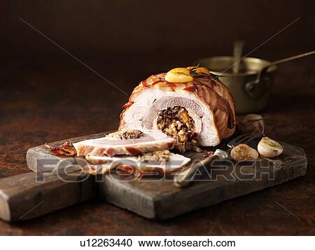 Stock Image - Christmas dinner. Three bird roast with garlic rosemary, apricot and bacon. Fotosearch