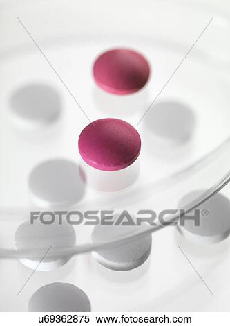 Close up of white and red pills in petri dishes View Large Photo Image Stock Photography - Close up of white and red pills in petri dishes. Fotosearch