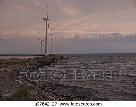 Coastal wind turbines at sunrise, Oland, Sweden View Large Photo Image Stock Photo - Coastal wind turbines at sunrise, Oland, Sweden. Fotosearch