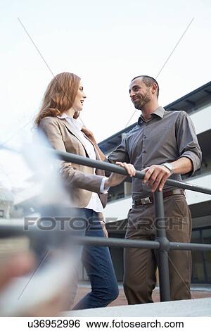 Stock Photograph - Couple chatting by railings. Fotosearch