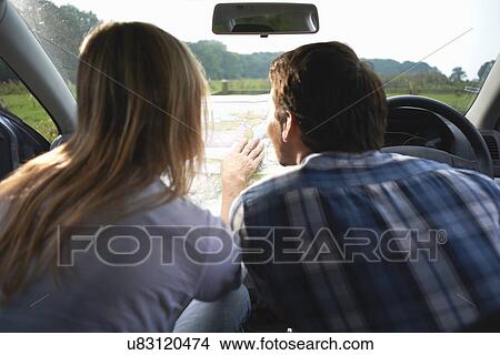 Picture - Couple in car map reading preparing for walk. Fotosearch