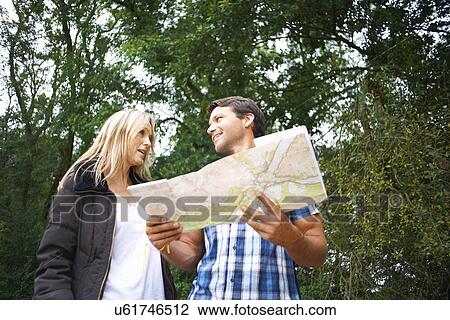 Stock Image - Couple map reading on walk. Fotosearch