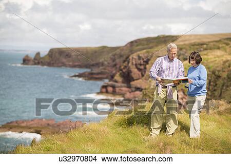 Couple reading map, Coast Path near Marloes, Pembrokeshire Coast National Park, Wales, UK View Large Photo Image Picture - Couple reading map, Coast Path near Marloes, Pembrokeshire Coast National Park, Wales, UK. Fotosearch