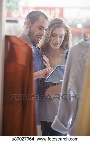 Couple shopping for clothes View Large Photo Image Picture - Couple shopping for clothes. Fotosearch