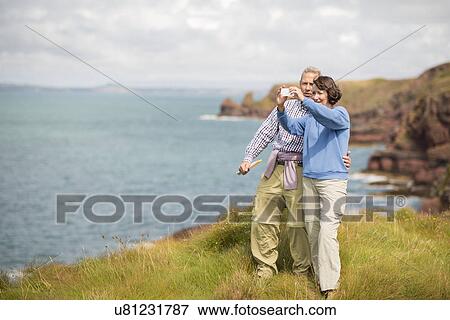 Stock Photo - Couple taking selfie, Coast Path near Marloes, Pembrokeshire Coast National Park, Wales, UK. Fotosearch