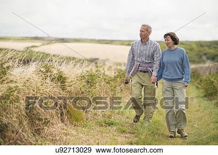 Stock Photo - Couple walking, Coast Path near Marloes, Pembrokeshire Coast National Park, Wales, UK. Fotosearch