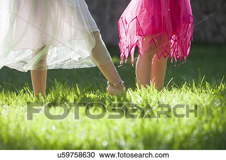 Cropped shot of the legs of two girls in fairy costume in garden View Large Photo Image Stock Image - Cropped shot of the legs of two girls in fairy costume in garden. Fotosearch