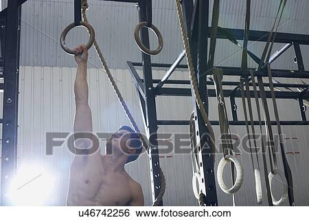 Stock Photograph - Crossfitter working out in gym. Fotosearch