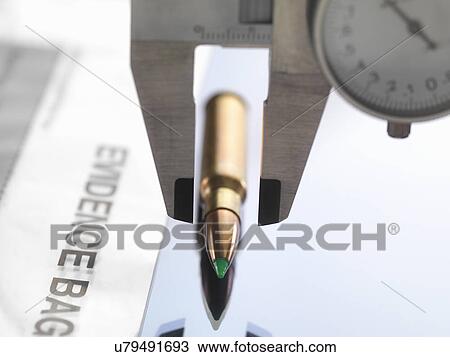 Dial calipers measuring bullet for forensic investigation View Large Photo Image Stock Image - Dial calipers measuring bullet for forensic investigation. Fotosearch