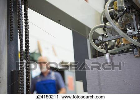 Stock Image - Factory worker at work. Fotosearch