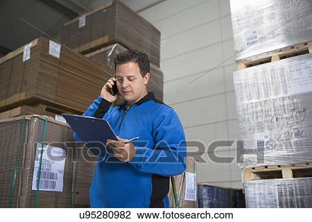 Factory worker checking pallets View Large Photo Image Stock Image - Factory worker checking pallets. Fotosearch