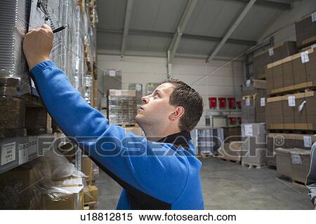 Factory worker checking pallets View Large Photo Image Stock Photography - Factory worker checking pallets. Fotosearch