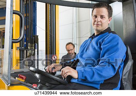 Picture - Factory worker operating forklift. Fotosearch