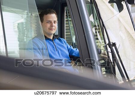 Stock Photo - Factory worker operating forklift. Fotosearch