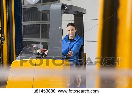 Stock Photo - Factory worker operating forklift. Fotosearch