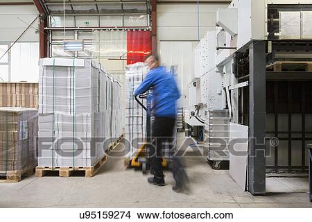 Factory worker operating pallet jack View Large Photo Image Picture - Factory worker operating pallet jack. Fotosearch