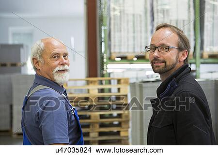 Picture - Factory worker with supervisor. Fotosearch