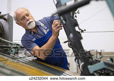 Factory worker working machinery View Large Photo Image Picture - Factory worker working machinery. Fotosearch