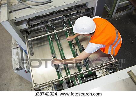 Factory worker working machinery View Large Photo Image Picture - Factory worker working machinery. Fotosearch