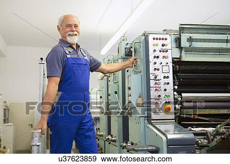 Factory worker working machinery View Large Photo Image Stock Photo - Factory worker working machinery. Fotosearch
