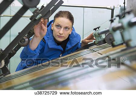 Stock Photo - Factory worker working machinery. Fotosearch