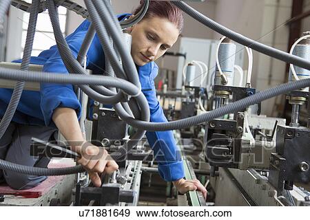 Factory worker working machinery View Large Photo Image Stock Photo - Factory worker working machinery. Fotosearch