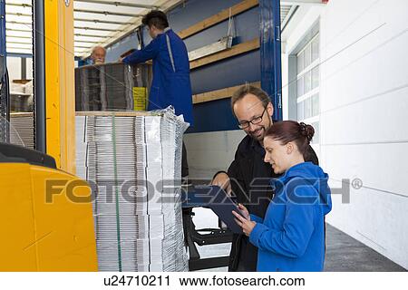 Factory workers by forklift View Large Photo Image Stock Image - Factory workers by forklift. Fotosearch